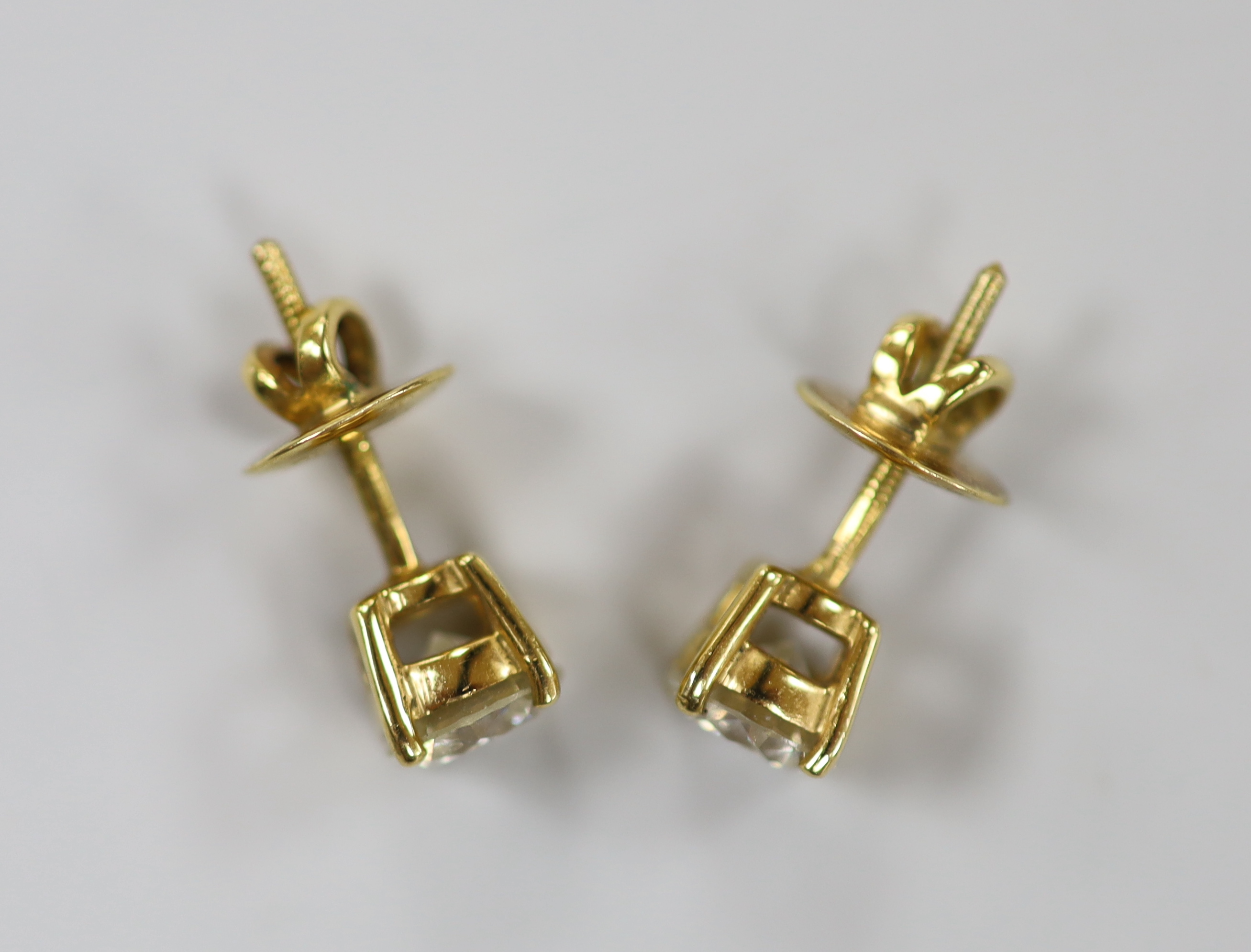 A pair of yellow metal and solitaire diamond set ear studs, gross weight 2.9 grams